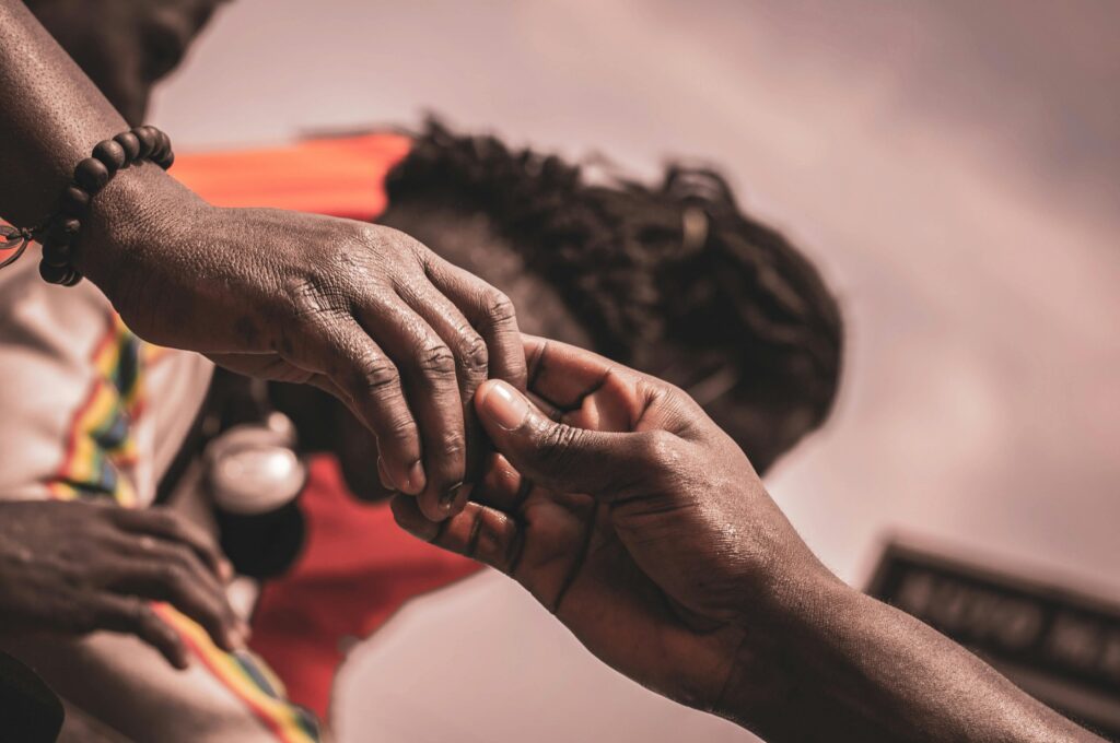 pexels-photo-5789276-5789276 Detailed close-up of hands interacting outdoors, with a blurred background suggesting connection.